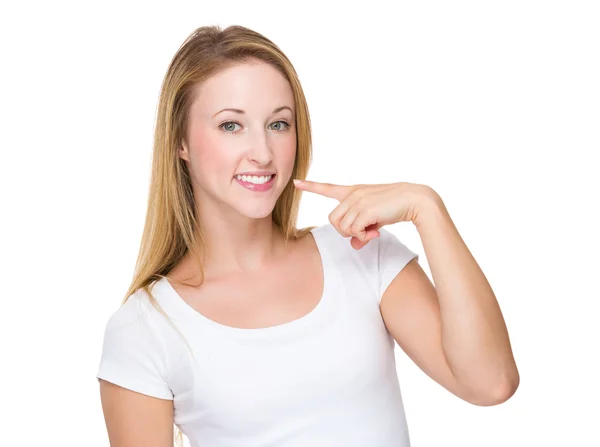 Woman pointing to teeth — Stock Photo, Image