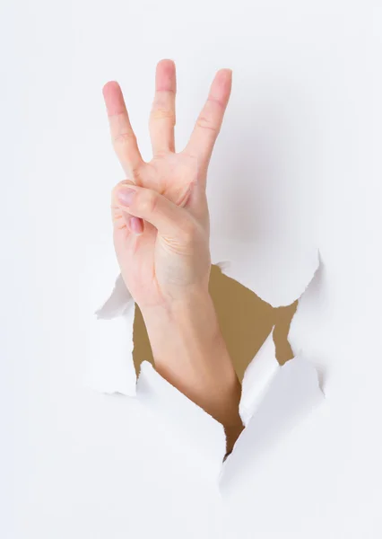 Three fingers breaking paper wall — Stock Photo, Image