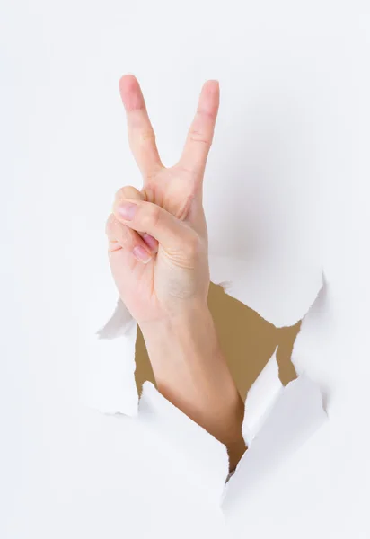 Woman hand breaking paper wall — Stock Photo, Image