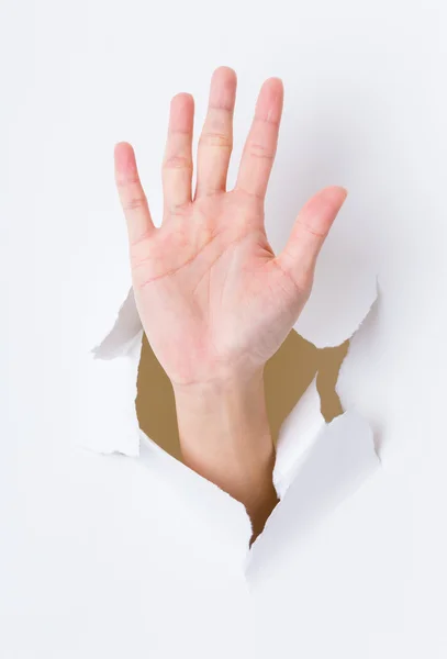 Hand palm breaking paper wall — Stock Photo, Image