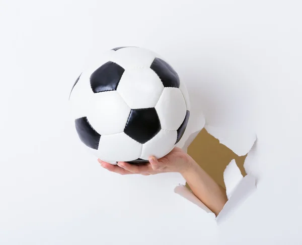 Soccer ball on female hand — Stock Photo, Image