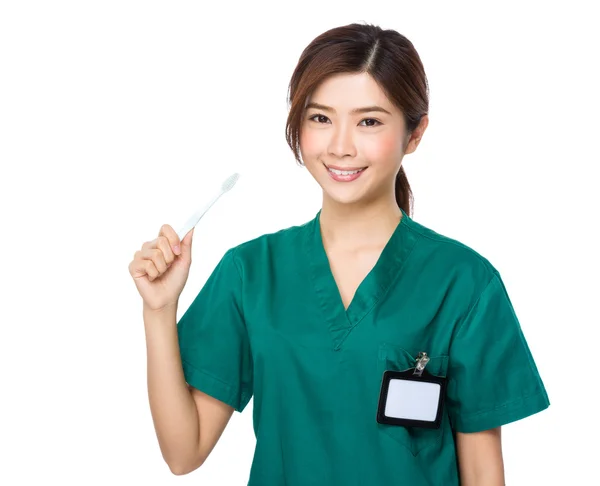 Asian doctor with toothbrush — Stock Photo, Image