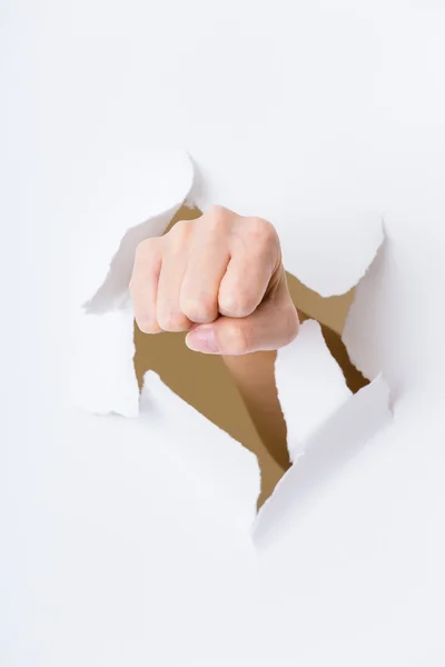 Fist out of paper hole — Stock Photo, Image