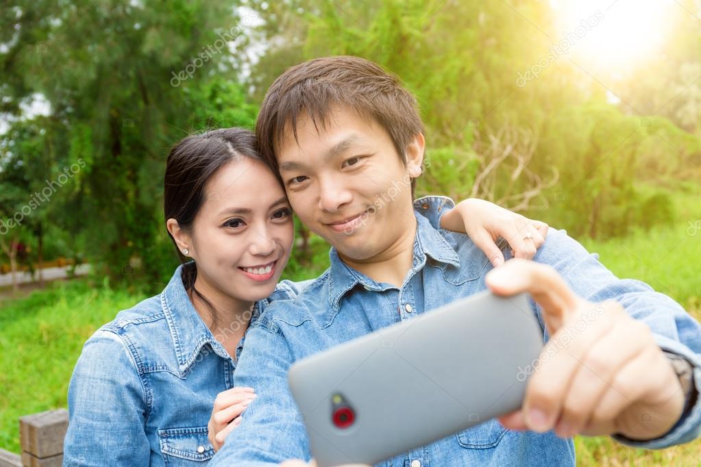 Outdoor watching asian couple