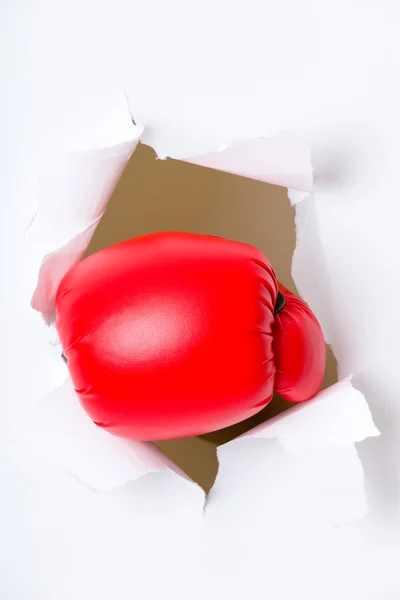 Luva de boxe através de papel branco — Fotografia de Stock