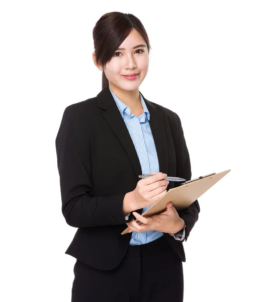 Asian businesswoman write on the clipboard — Stock Photo, Image