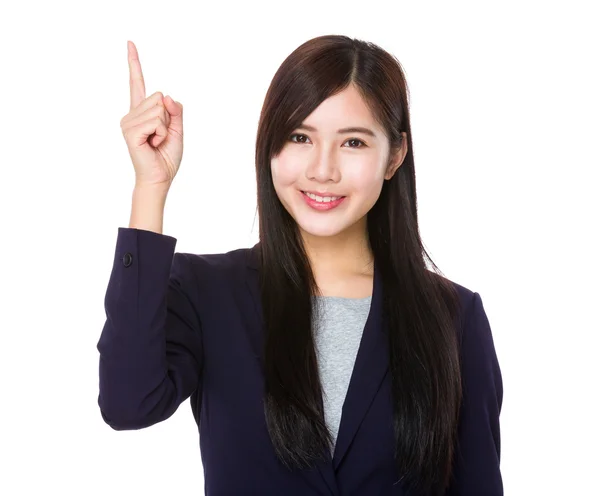 Businesswoman with finger showing upwards — Stock Photo, Image