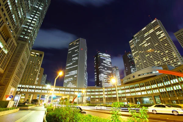 Car light trails and urban landscape — Stock Photo, Image