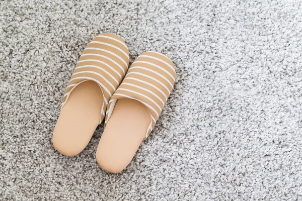 Slippers on grey carpet — Stock Photo, Image