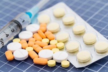 syringe and medical pills
