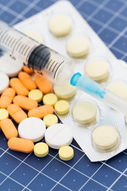 syringe and medical pills