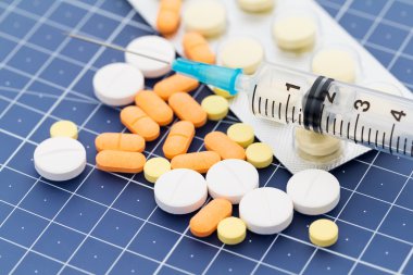 syringe and medical pills