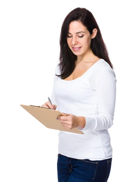 Caucasian brunette woman in white sweater Stock Picture