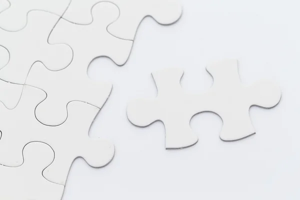 Plain white jigsaw puzzle — Stock Photo, Image