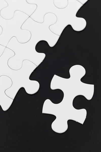 White unfinished jigsaw puzzle — Stock Photo, Image