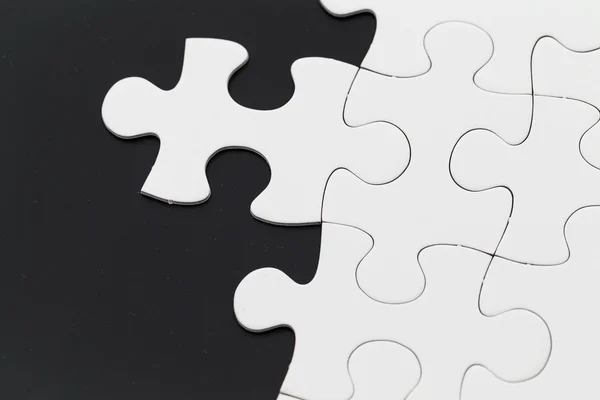 White unfinished jigsaw puzzle — Stock Photo, Image