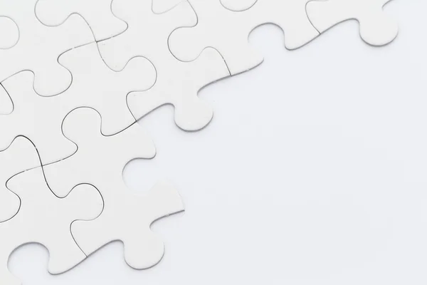 Incomplete white jigsaw puzzle — Stock Photo, Image