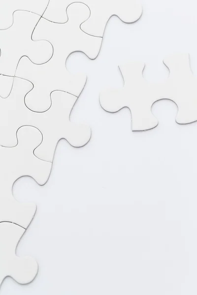 Incomplete white jigsaw puzzle — Stock Photo, Image