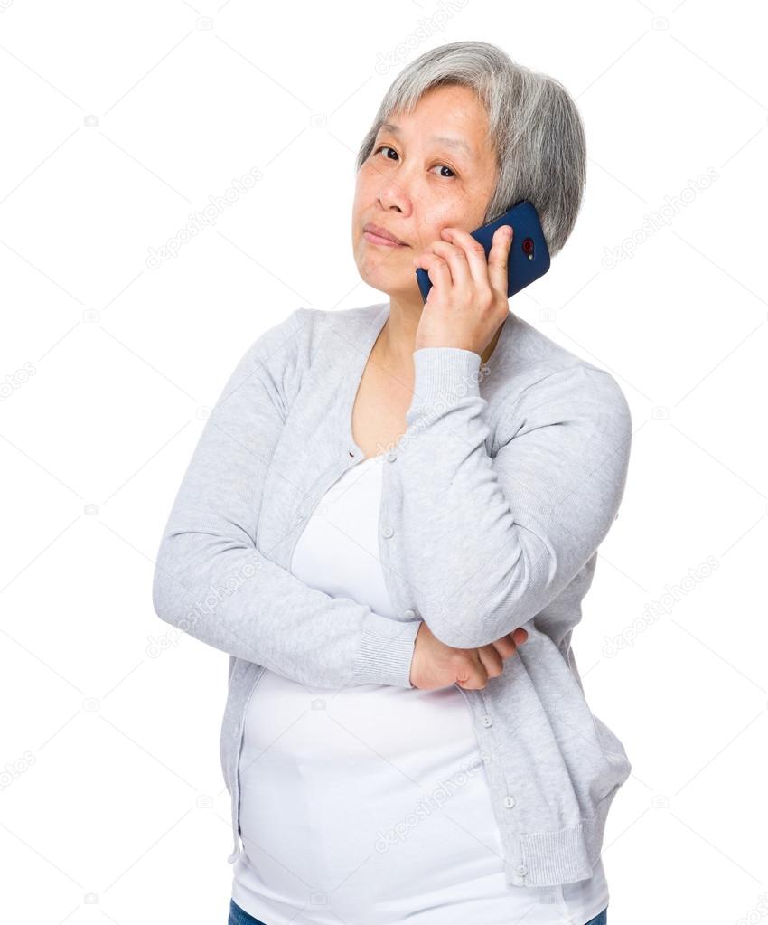 Asian mature woman in grey cardigan