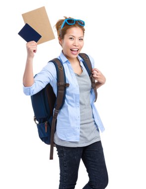 woman holding passport and information for the trip
