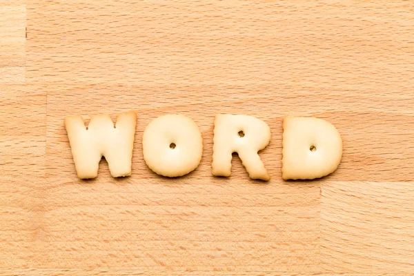 Letter word cookie over the wooden — Stock fotografie