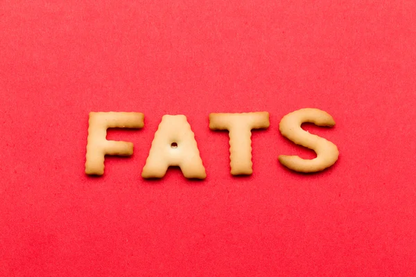 Mot Fats biscuit sur le fond rouge — Photo