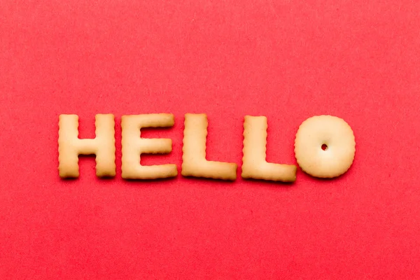 Word hello cookie over the red background — Stock Photo, Image