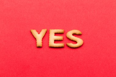Word yes biscuit over the red background
