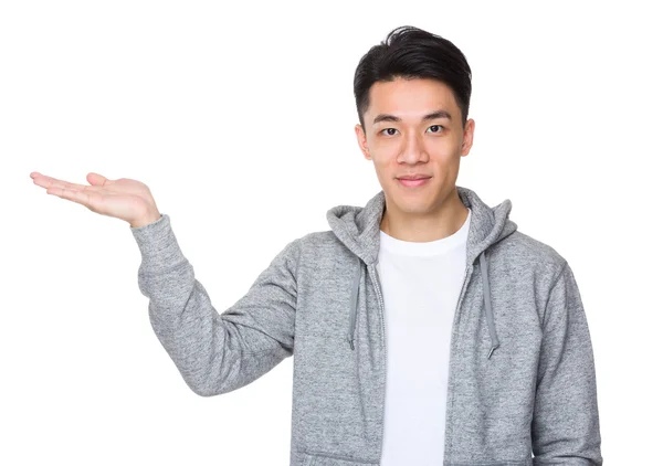 Asian young man with open hand palm — Stock Photo, Image