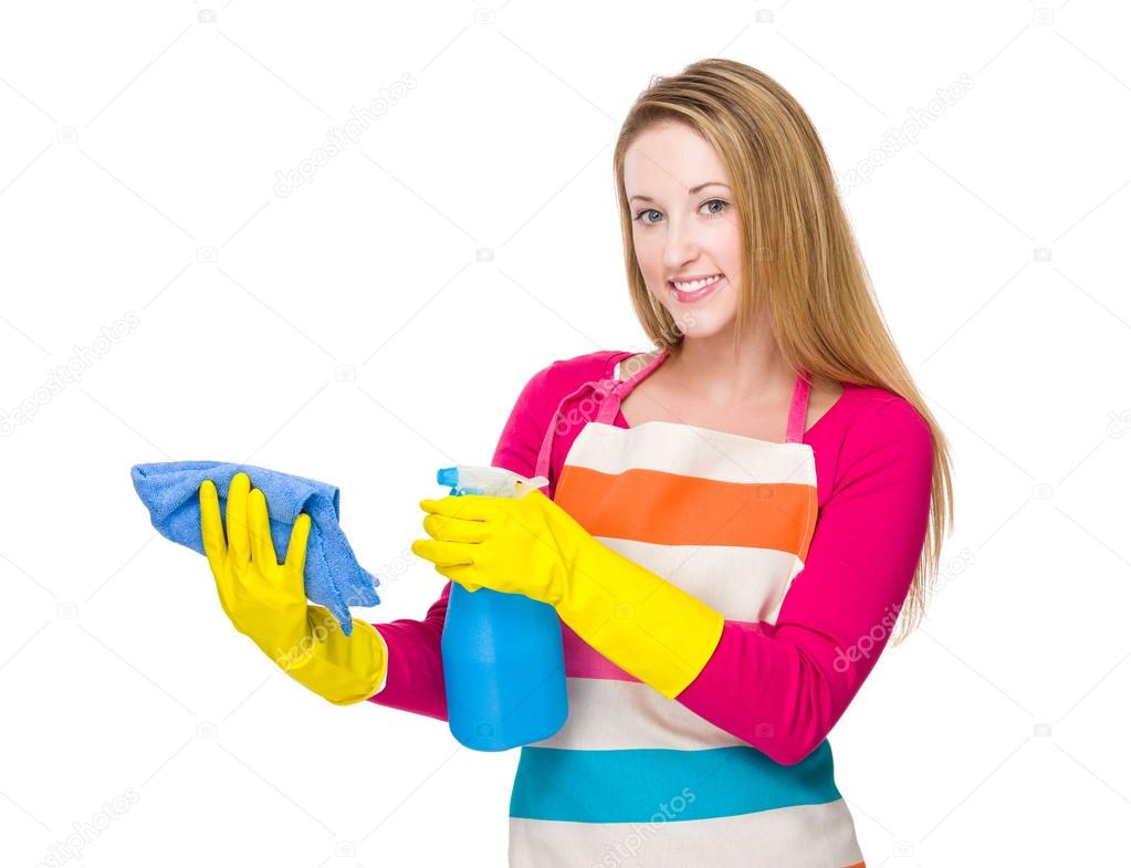 Woman using the bottle spray and rag for cleaning