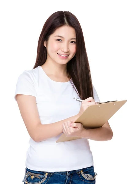 Asian woman take note on clipboard — Stock Photo, Image