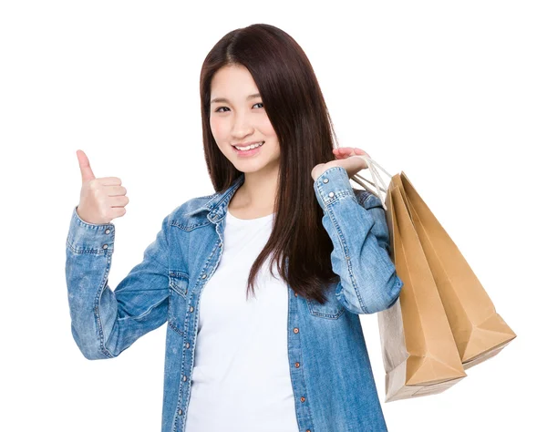 Asian young woman showing thumb up with shopping bags — Φωτογραφία Αρχείου