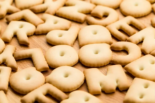 Text Biscuit over the wooden table — Stok fotoğraf