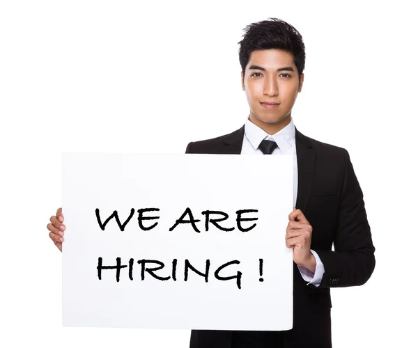 Confident businessman holding a poster — Stock Photo, Image