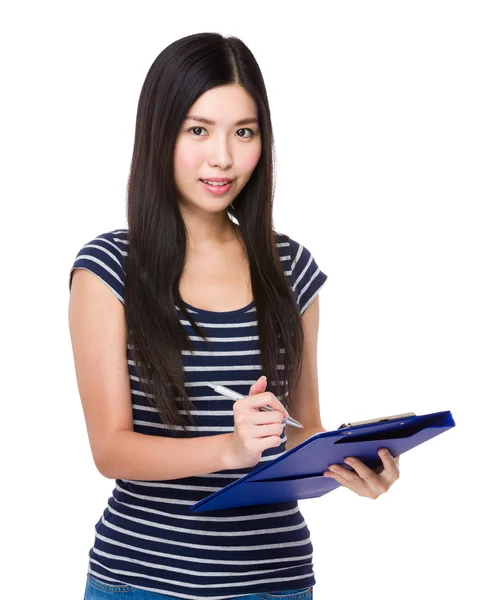 Young asian woman write on clipboard — Stock Photo, Image