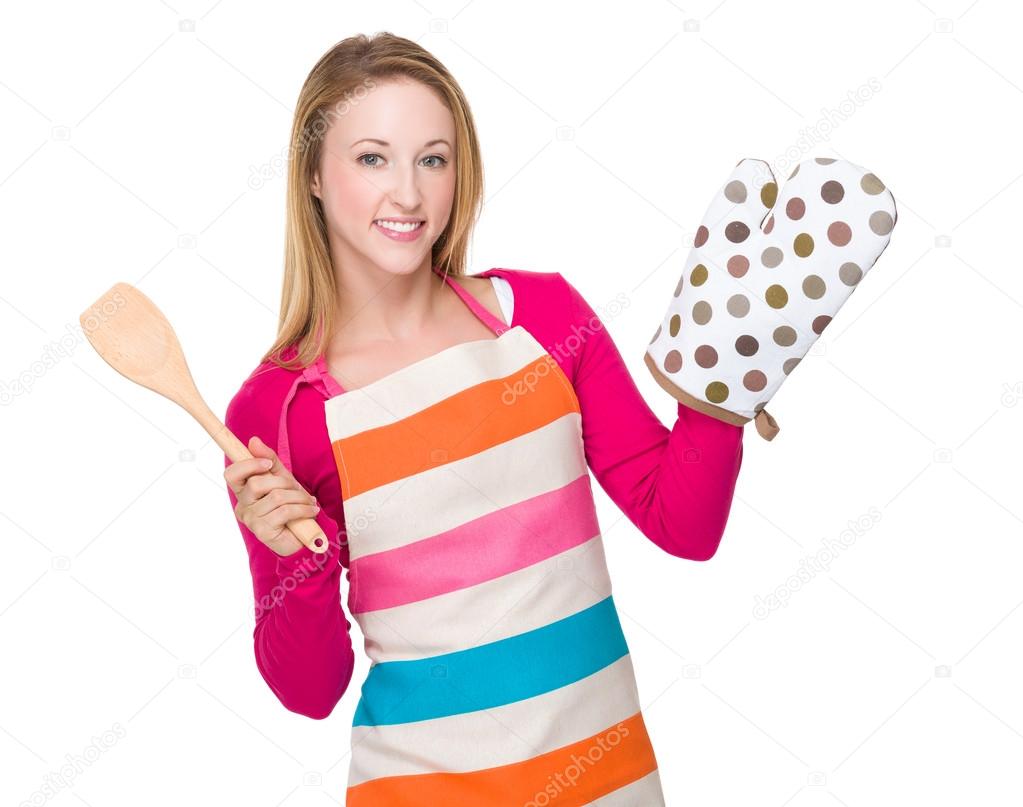 housewife with oven glove and ladle
