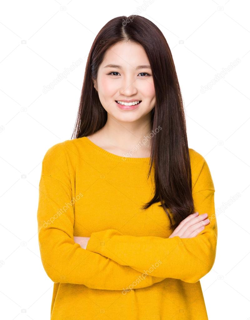 Asian young woman in yellow sweater with arms crossed