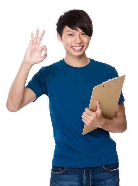 Young man holding  clipboard — Stock Photo, Image