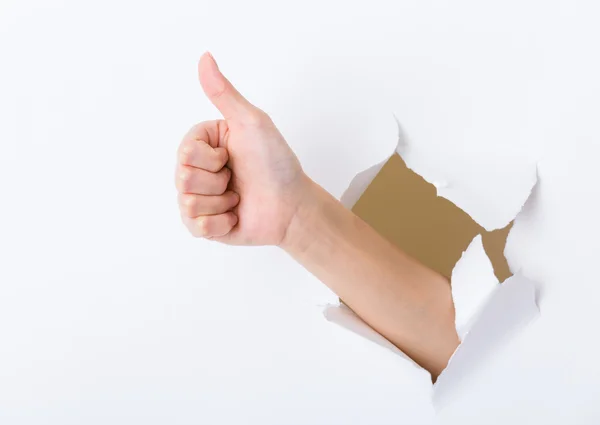 Hand break through paper with thumb up sign — Stock Photo, Image