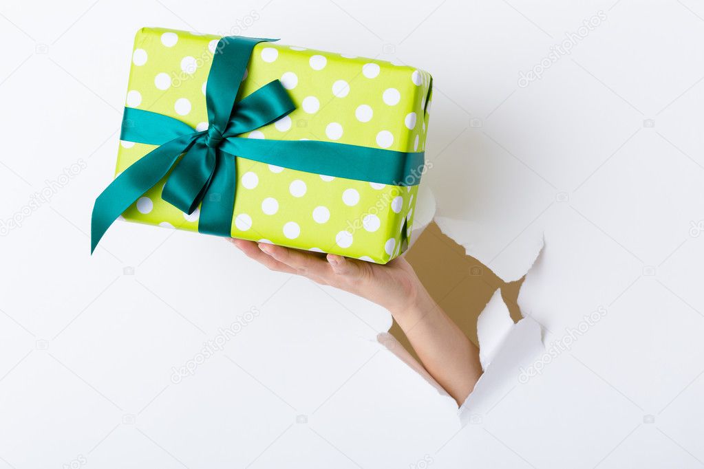 Hand with green present box
