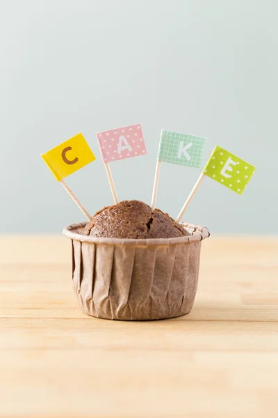Chocolate muffin with small flag — Stock Photo, Image