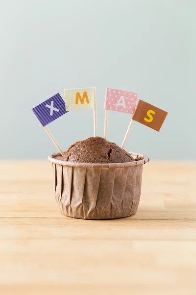 Chocolate muffin with small flags — Stock Photo, Image