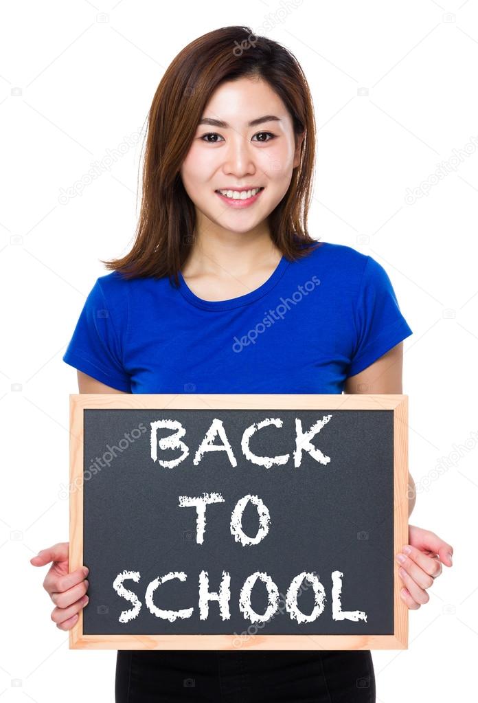 Asian woman in blue t-shirt with blackboard