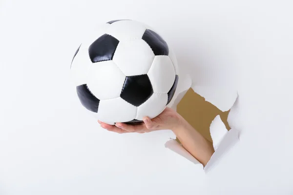 Hand holding soccer ball — Stock Photo, Image