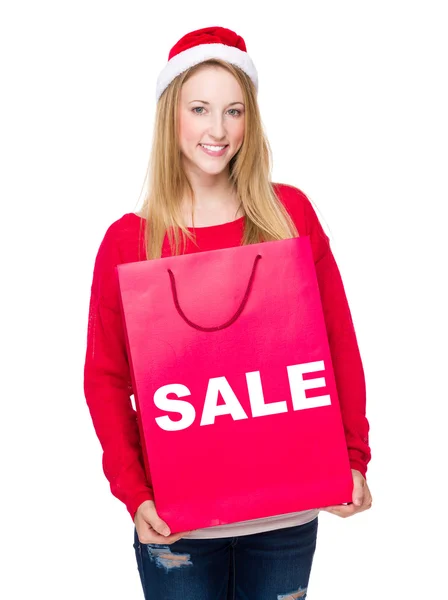 Mujer en sombrero de Navidad con bolsa de papel —  Fotos de Stock