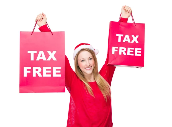 Woman in Christmas hat hold up paper bags — Stock Photo, Image