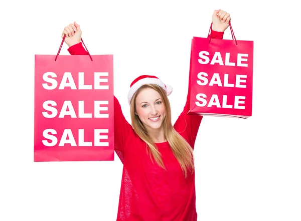 Mujer en sombrero de Navidad sostienen bolsas de papel —  Fotos de Stock