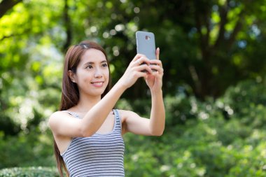 Kadın cep telefonuyla fotoğraf çekmek