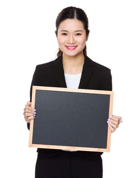 Businesswoman holding blackboard — Stock Photo, Image