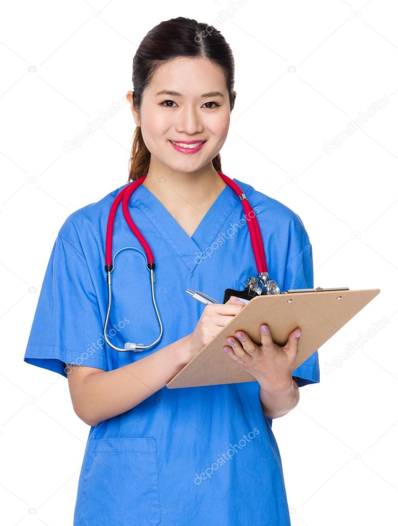 Asian doctor taking note